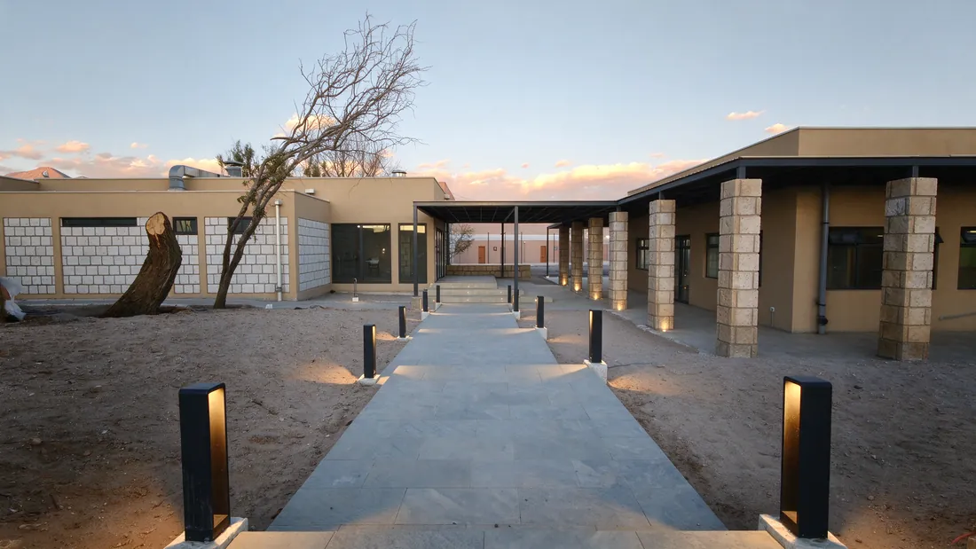 Inner courtyard with stone walls and a lit path